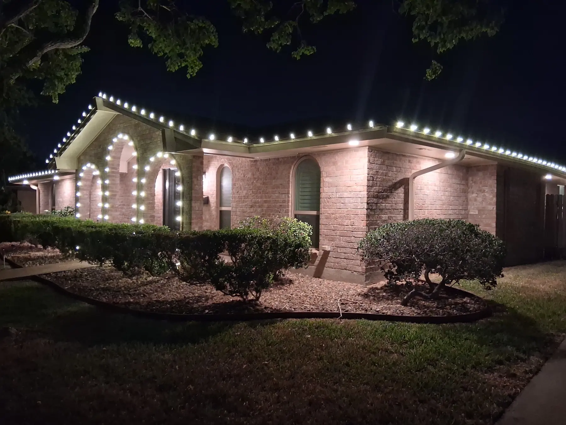 Warm white Christmas light installation serving Portland Texas