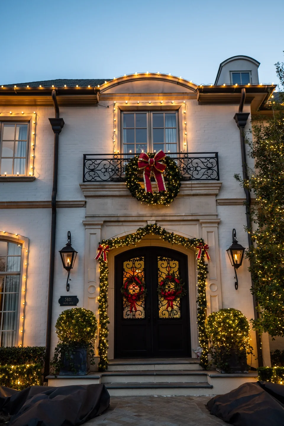 Holiday wreath and professional entry lighting on a Corpus Christi home